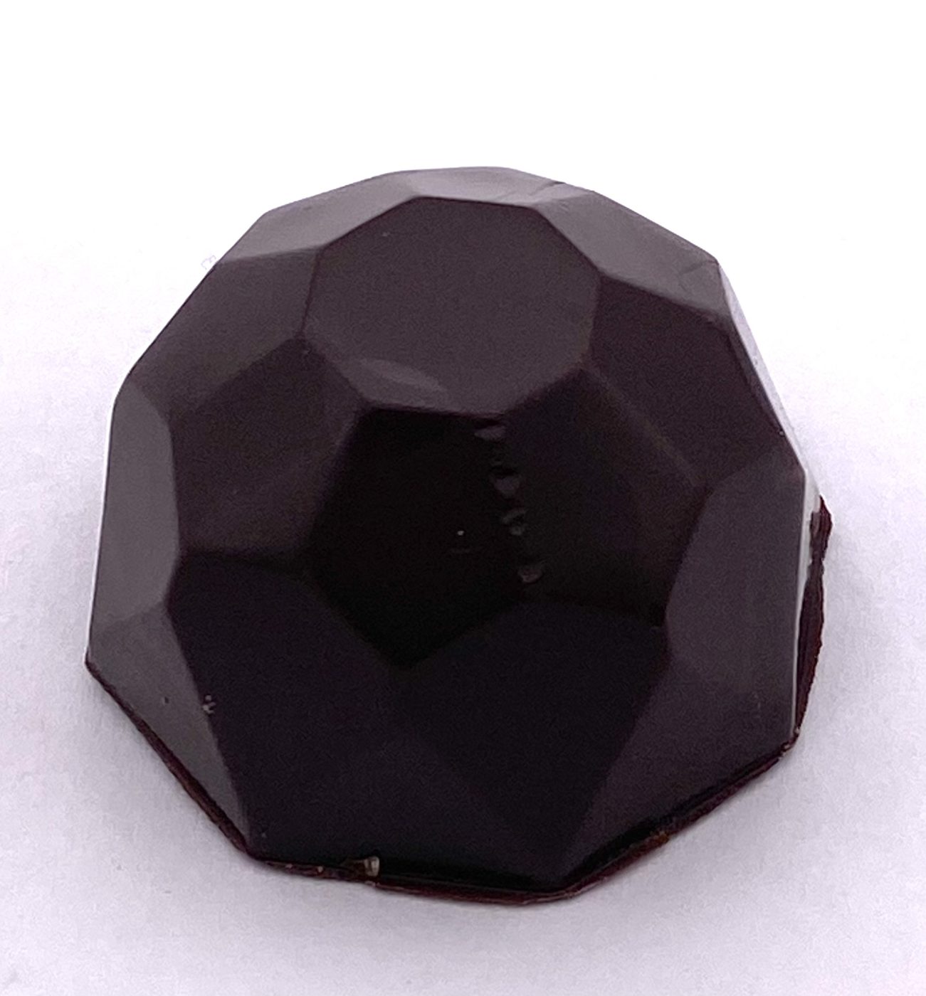 A single faceted dark chocolate Buzz Bite